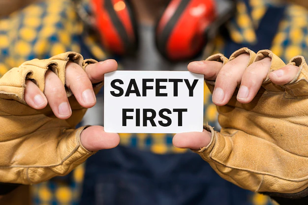 front-view-hands-holding-safety-first-sign_23-2149919543